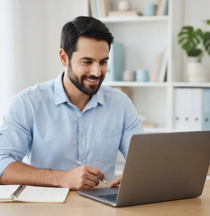 Smiling entrepreneur studying on a laptop