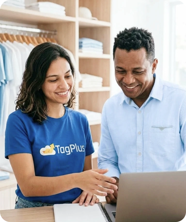 TagPlus professional showing the system on a laptop to a smiling shop owner in a tidy store