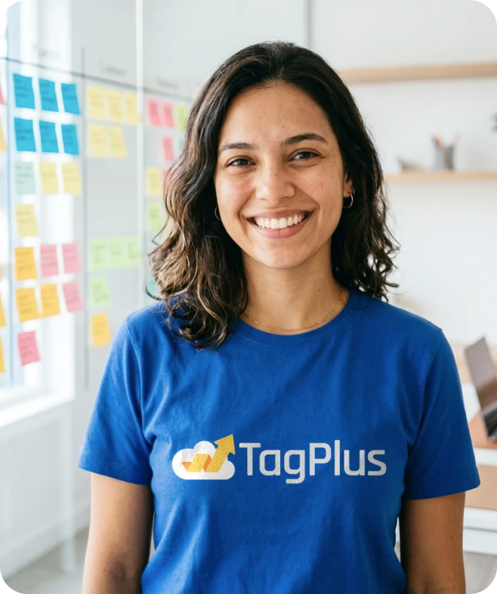 Smiling woman wearing a TagPlus T-shirt in an office
